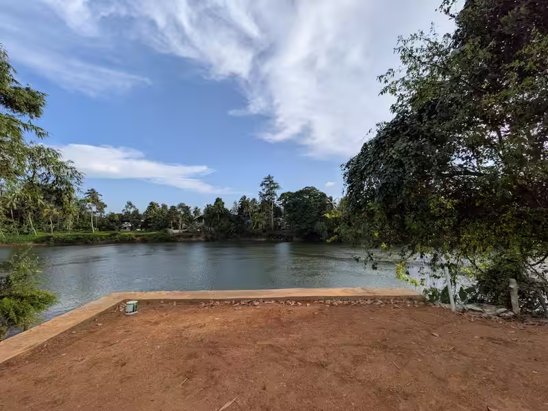 Serene panoramic view of the Manimala River from Riverside Retreat homestay in Thiruvalla